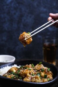 Overhead shot of General Tso’s tofu—crispy tofu coated in glossy sauce, paired with rice.