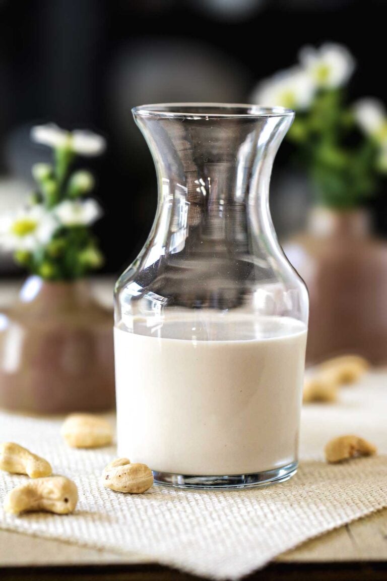 Freshly blended cashew cream in a glass carafe, made from soaked raw cashews.