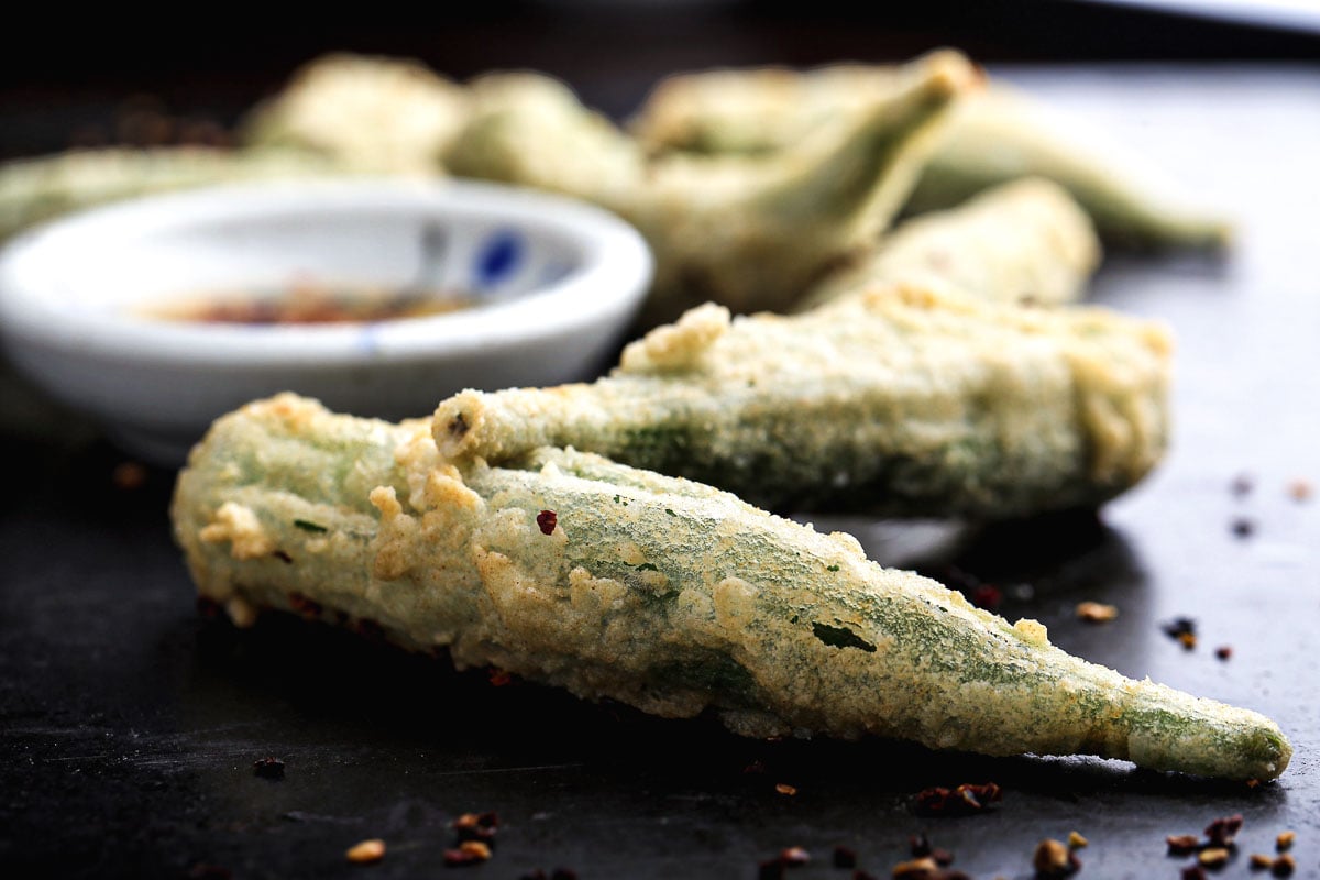 Close-up of crispy vegan fried okra with golden batter.