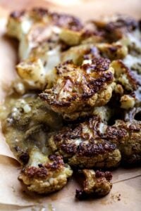 Roasted cauliflower steak topped with vegan oyster mushroom gravy and sage.