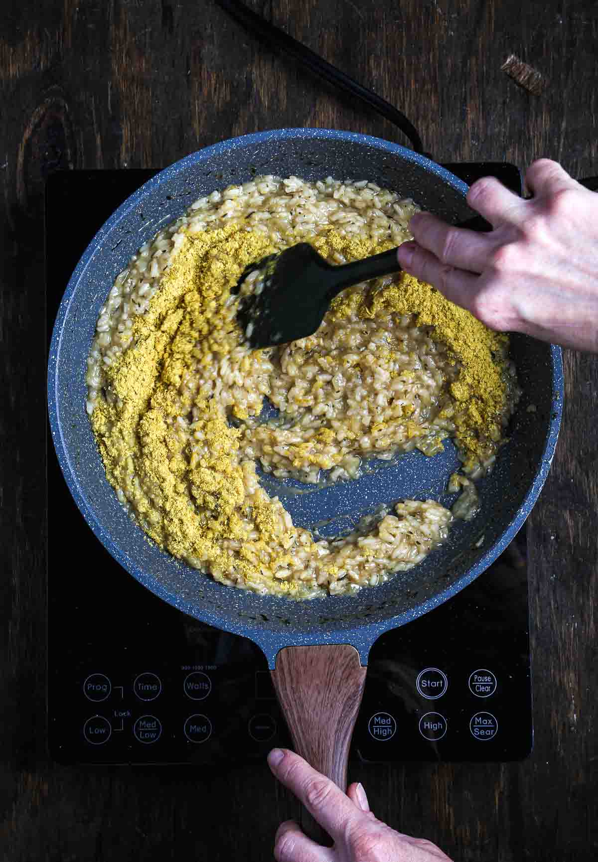 Vegan parmesan stirred into risotto to finish a dairy-free mushroom risotto.