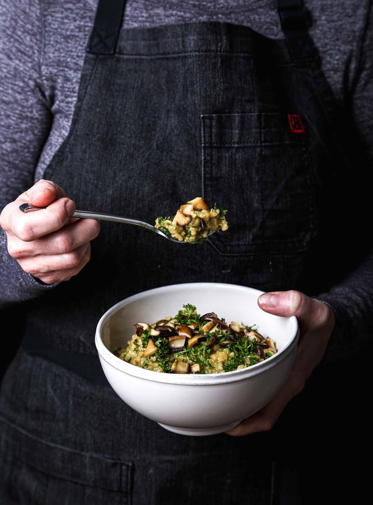Creamy vegan mushroom risotto with arborio rice and golden-brown shiitake mushrooms.