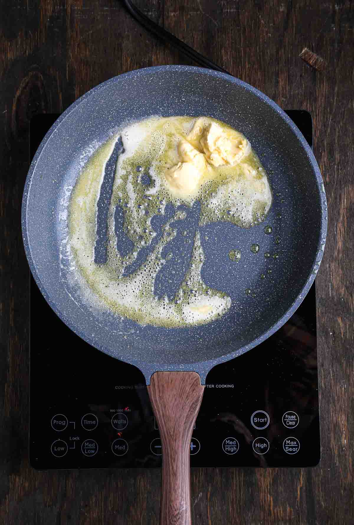 Vegan butter melting in a pan to start the base of a vegan risotto.