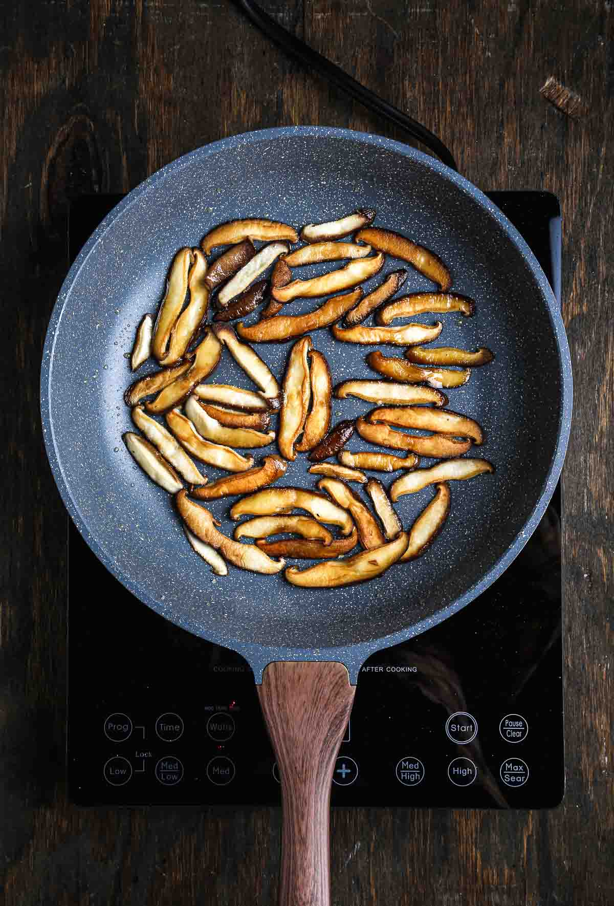 Golden-brown shiitake mushrooms seared until caramelized for mushroom risotto.