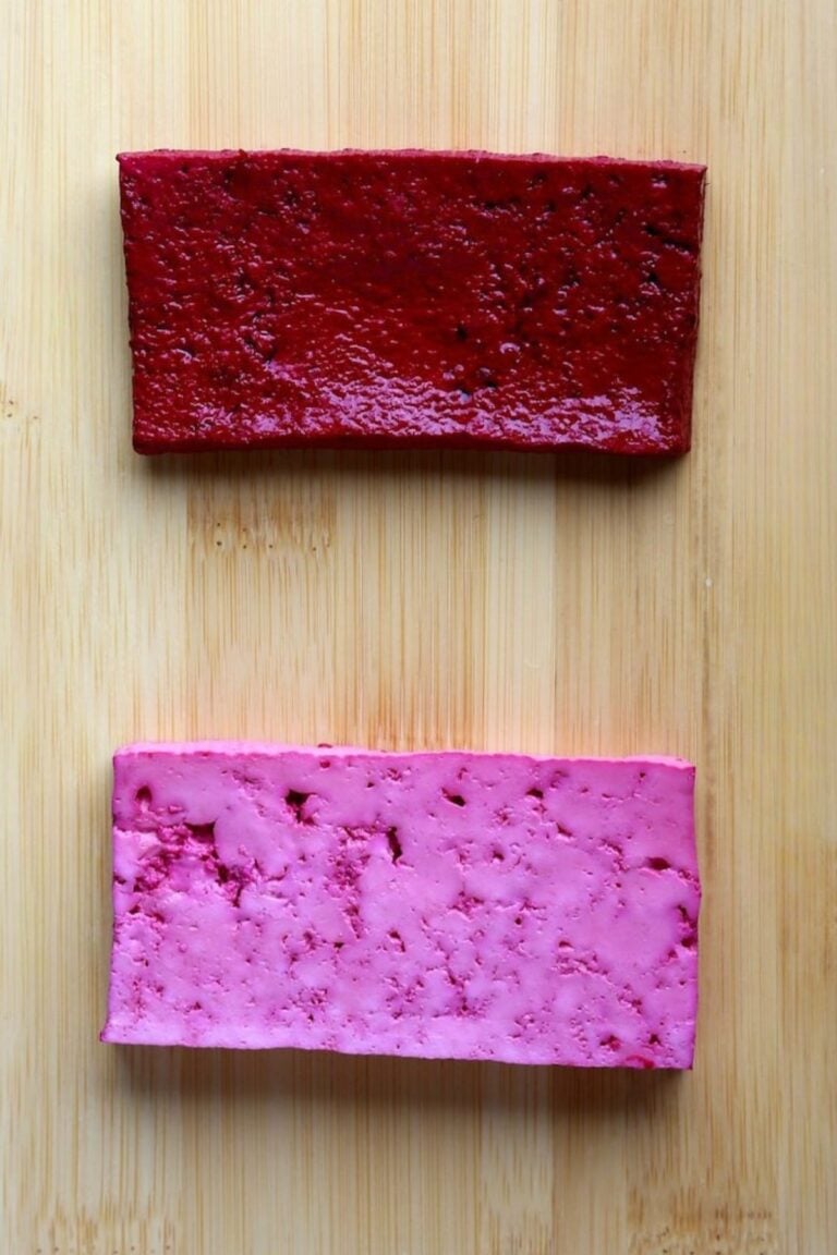 Side-by-side comparison of two pressed tofu slices after marinating, showing deeper absorption with the towel method.