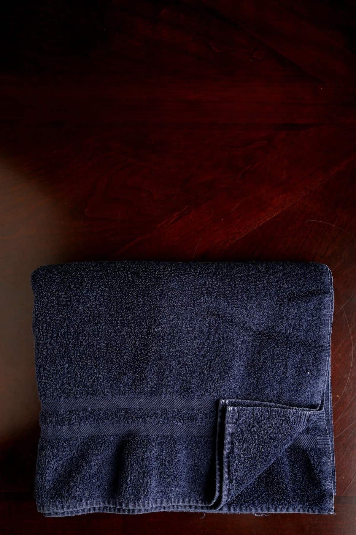 A thick folded bath towel used to press tofu without a tofu press.