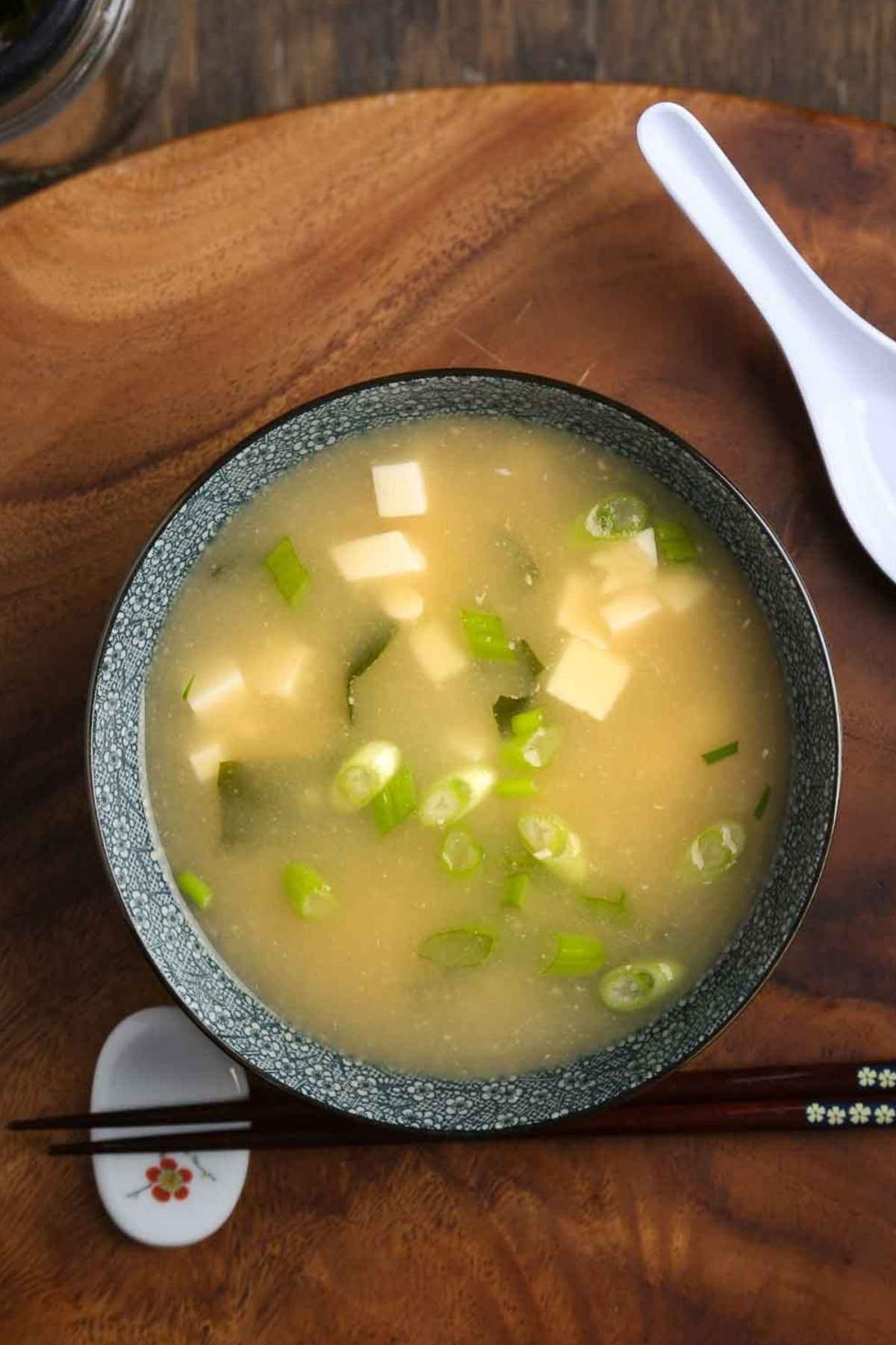 Vegan miso soup with tofu, wakame, and scallions in a ceramic bowl.