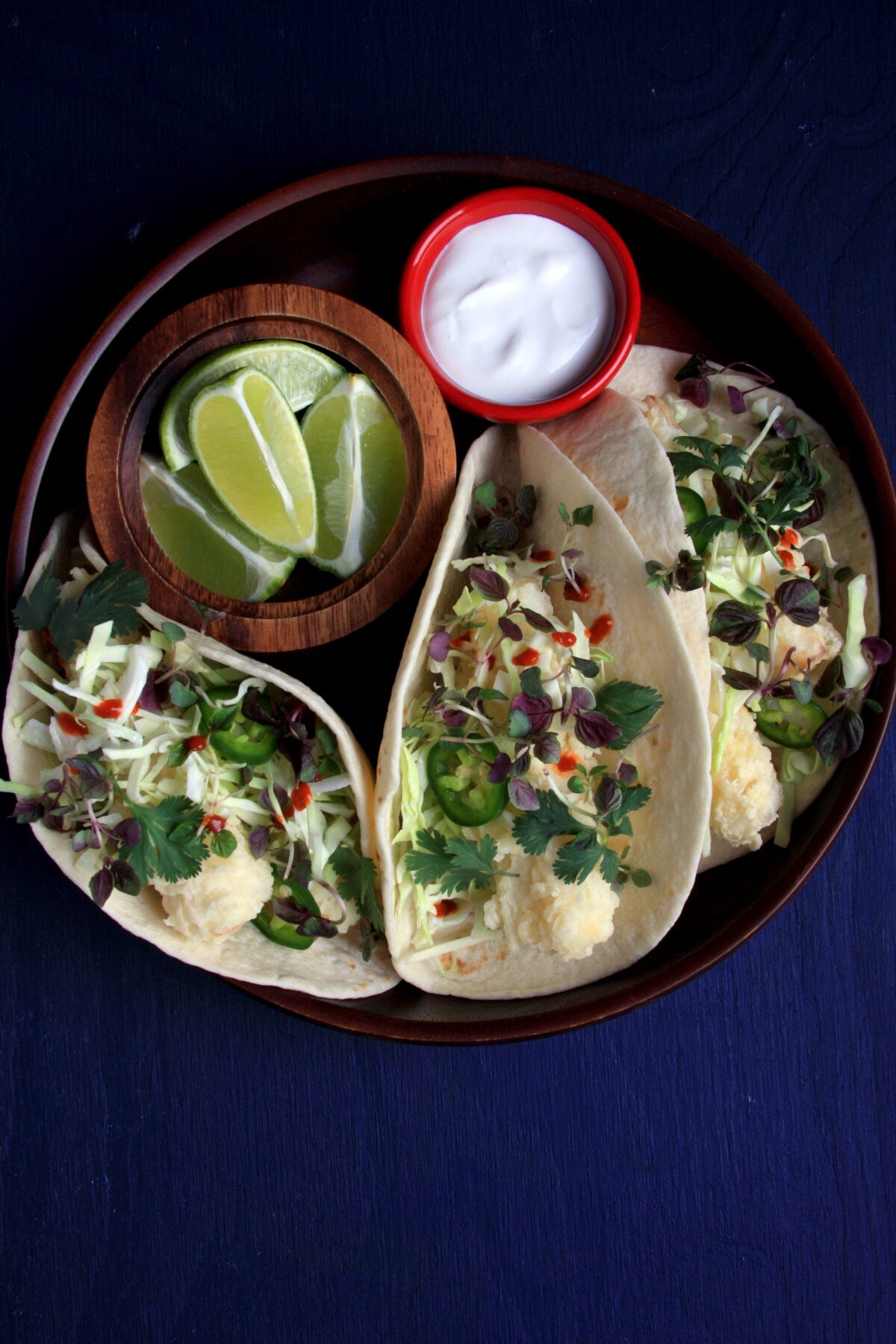 Crispy hearts of palm tacos with cabbage, avocado, cilantro, and lime.