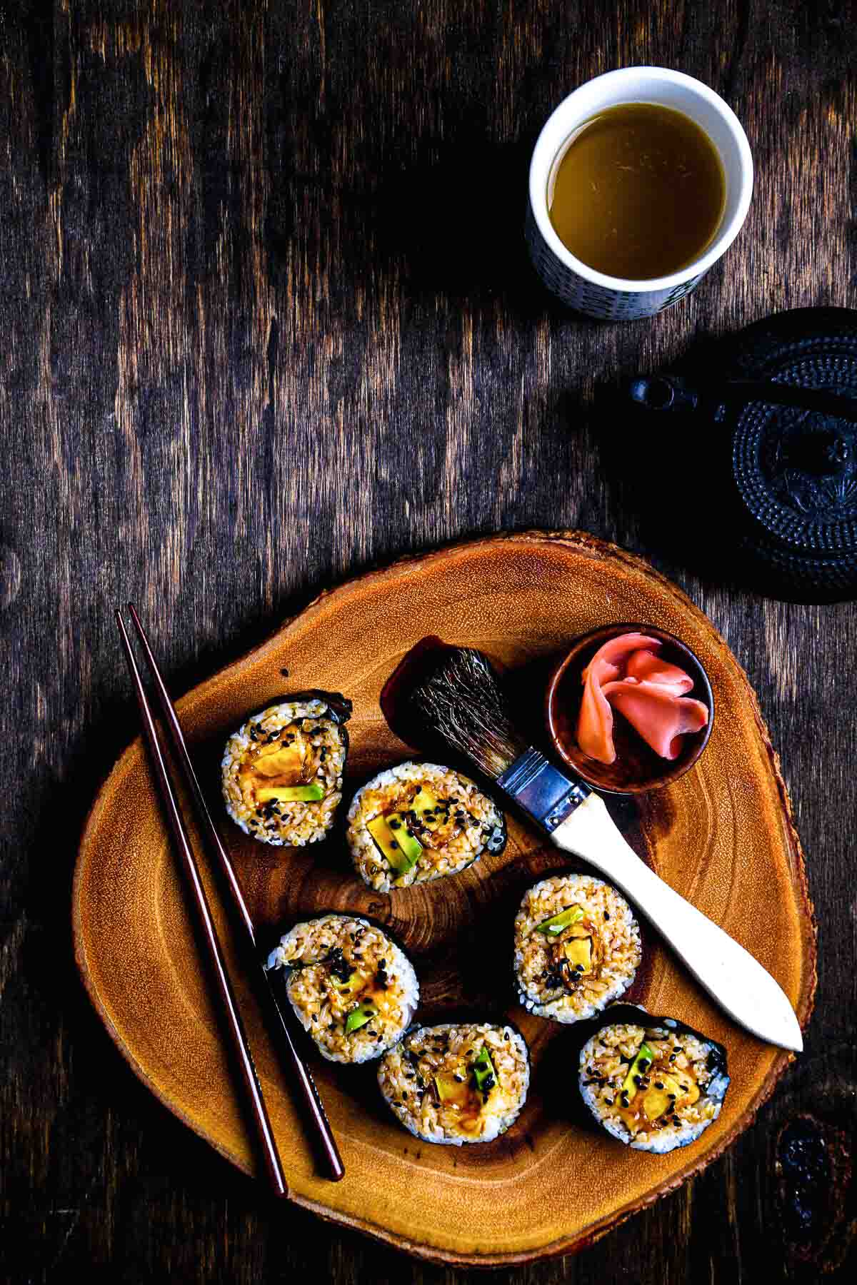 Nori-wrapped rolls with avocado and tempura sweet potato brushed with teriyaki glaze for a glossy, savory finish.