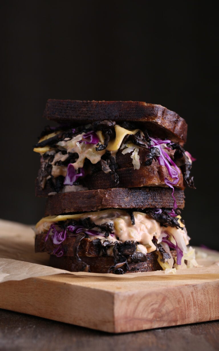A vegan reuben shot against a dark background.