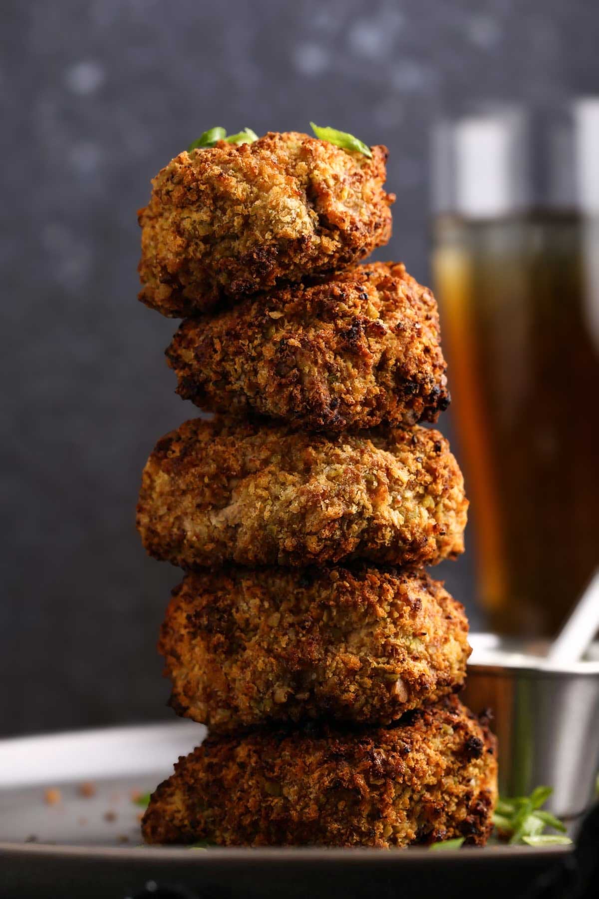 Stack of golden, crispy air fried breaded mushrooms with a crunchy sriracha-panko coating.