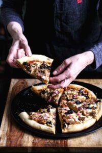 Baked vegan pizza with golden crust, sliced and ready to serve.