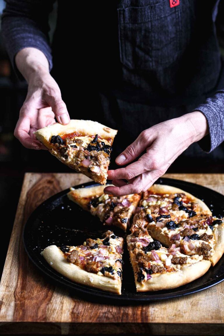 Baked vegan pizza with golden crust, sliced and ready to serve.
