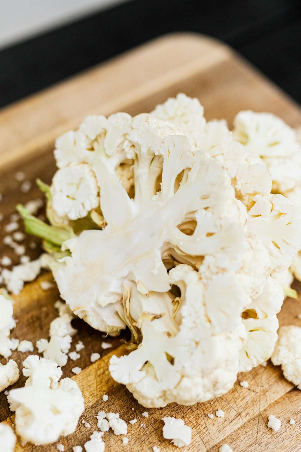 Cauliflower cut into thick slabs for roasted cauliflower steak prep.