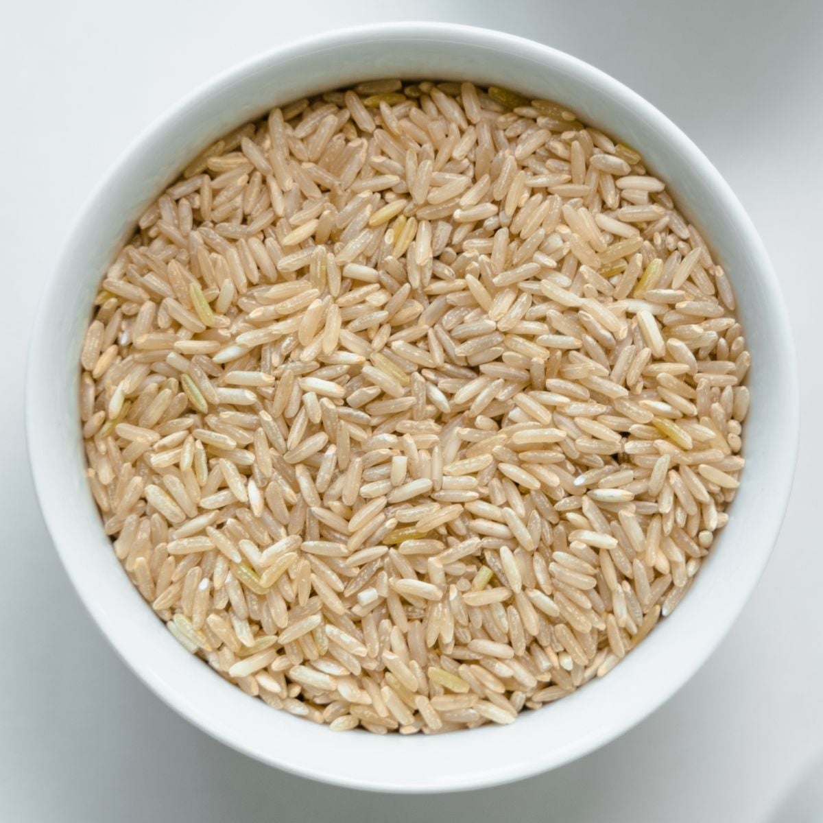 Dry brown rice in a bowl.