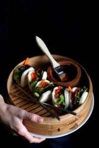 Vegan pork buns with fresh herbs and oyster mushroom bacon.
