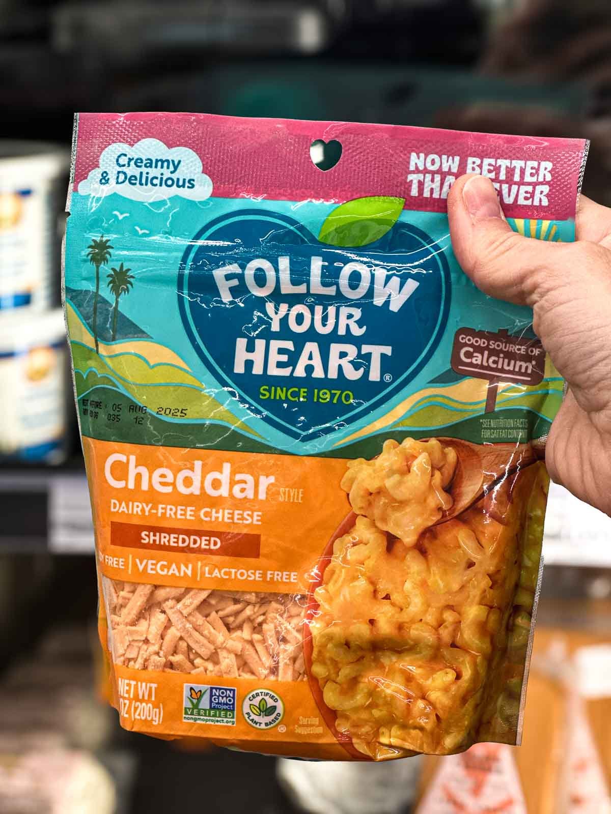 Bag of Follow Your Heart dairy-free cheddar shreds, a melty vegan cheese for nachos or mac and cheese.