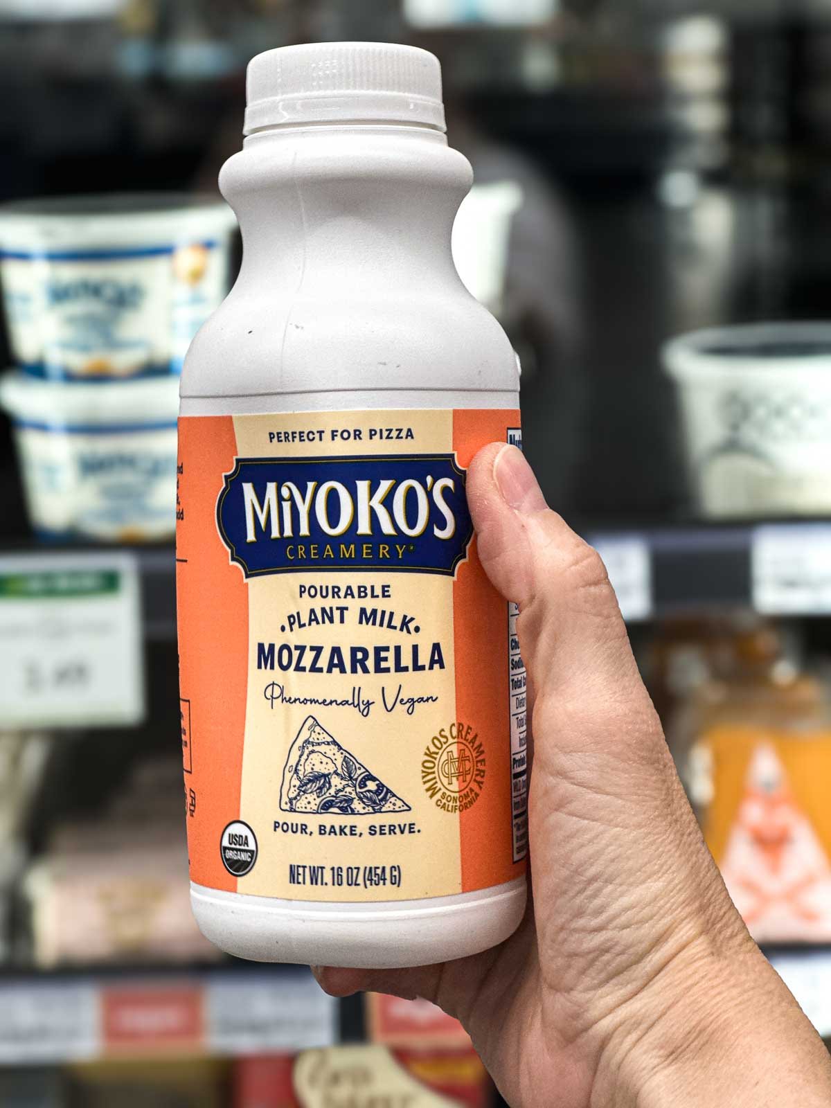 Bottle of Miyoko’s pourable plant milk mozzarella—great for vegan pizza or grilled cheese.