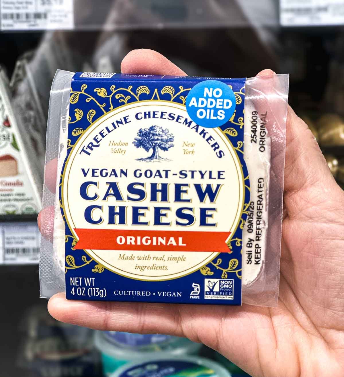 Treeline goat-style vegan cashew cheese block in blue and gold packaging, made with simple ingredients and no added oils.