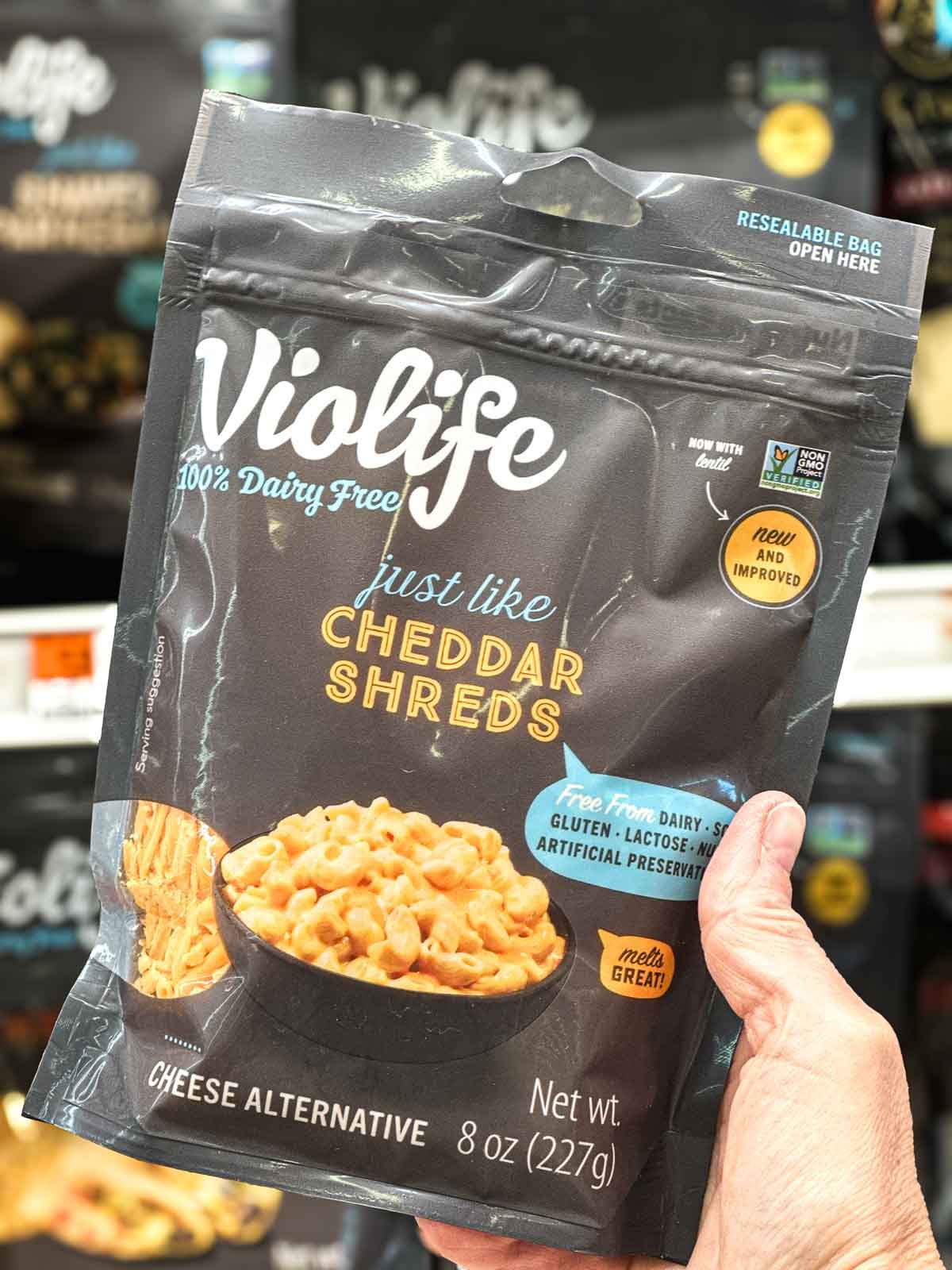 Package of Violife cheddar-style shreds, a plant-based cheese that melts well in hot dishes.