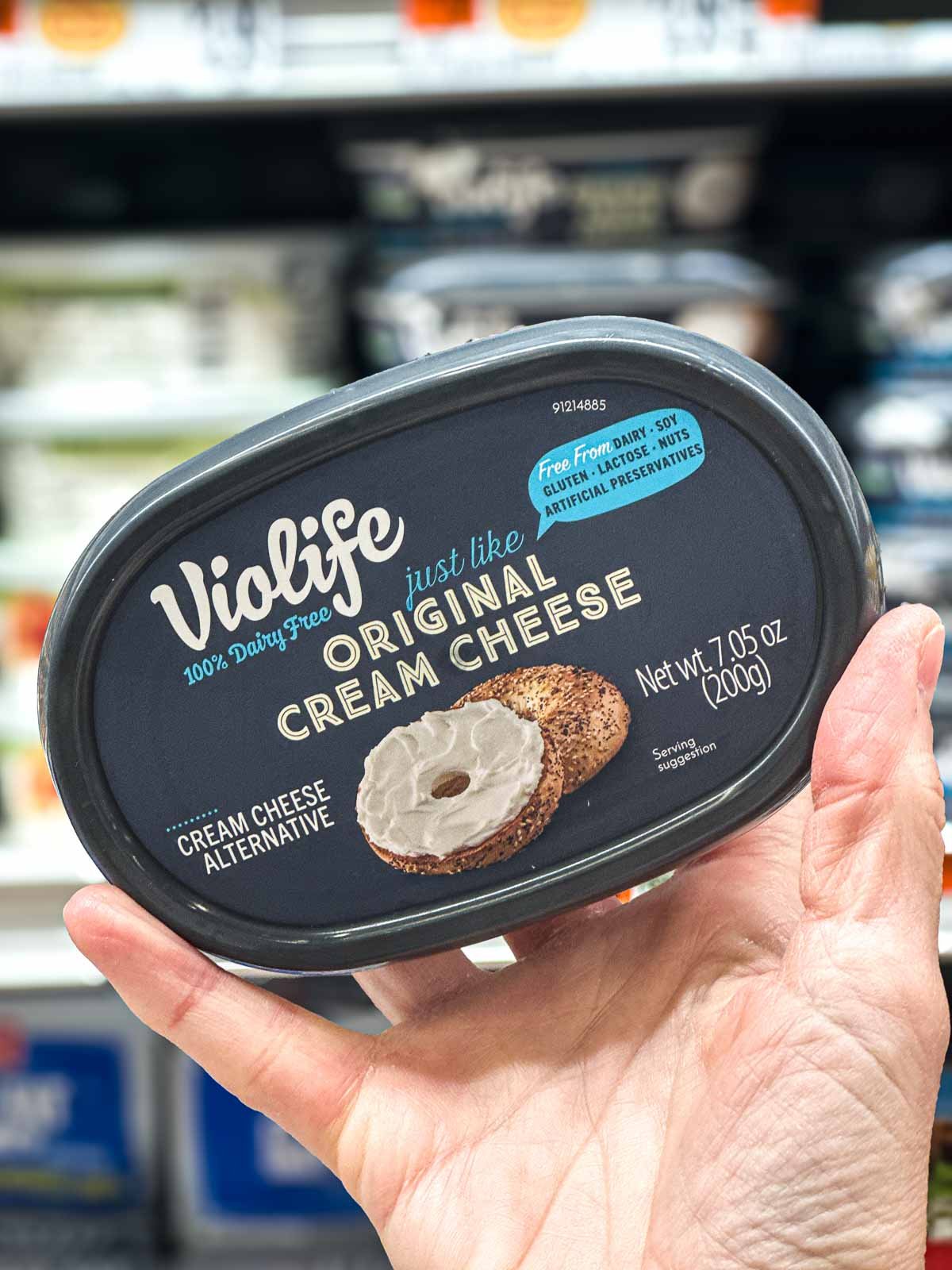Violife vegan cream cheese tub with black label and bagel image, dairy-free spread.