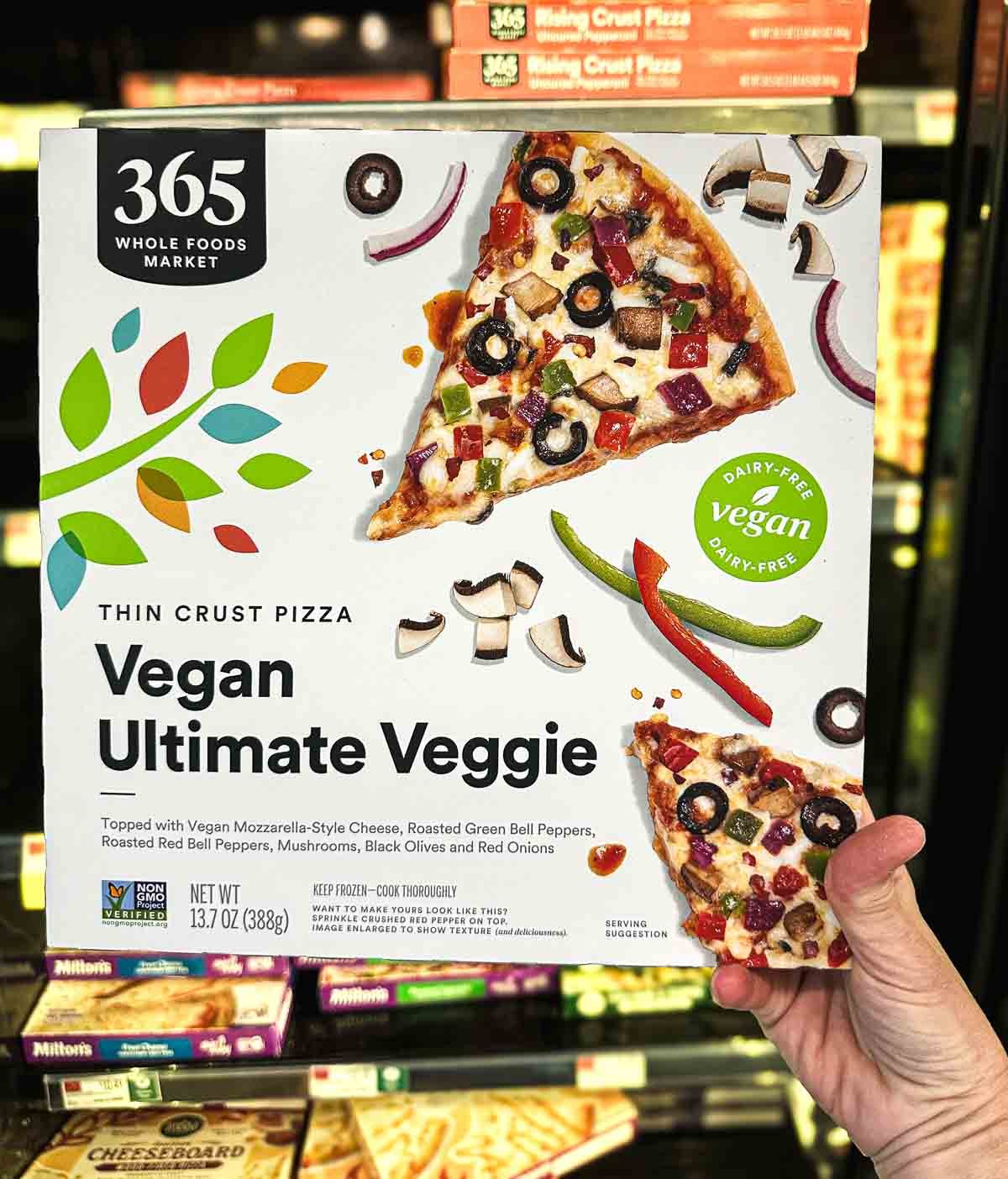 Whole Foods 365 brand vegan veggie pizza with mushrooms, olives, and dairy-free cheese.