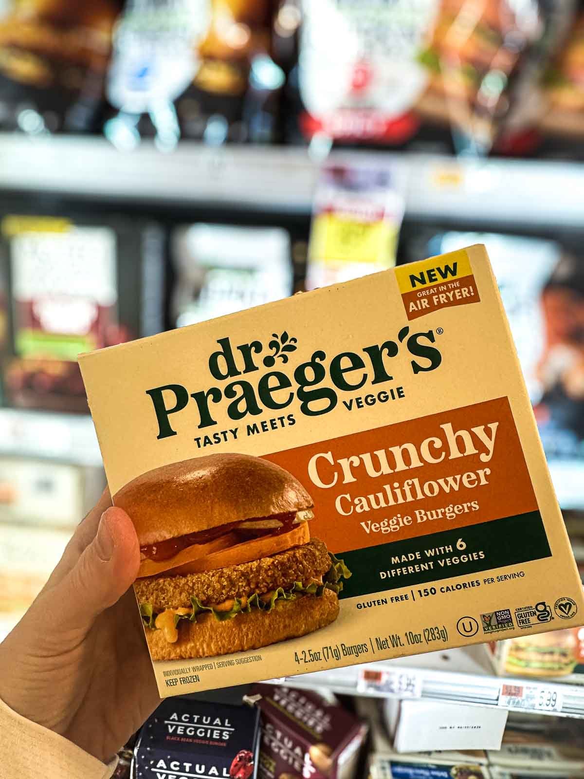 Dr. Praeger’s Crunchy Cauliflower veggie burgers found in the vegan frozen foods section of a grocery store.