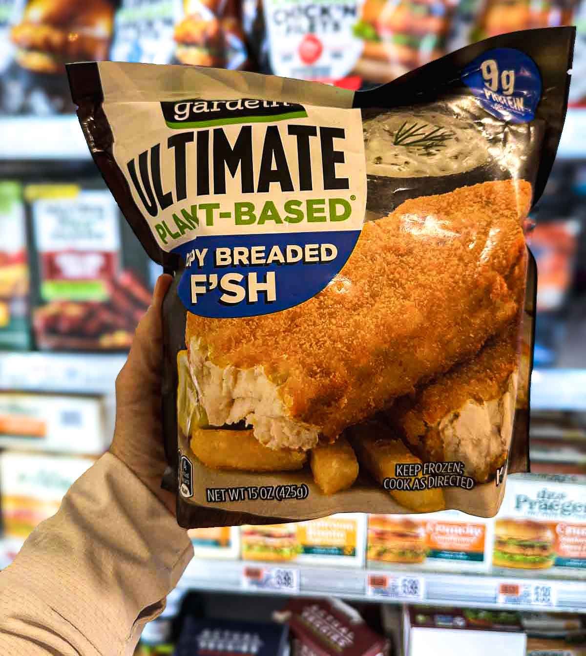 Gardein Ultimate Plant-Based Fish Filets in a crispy breaded coating, displayed in the vegan frozen foods section of the freezer aisle.