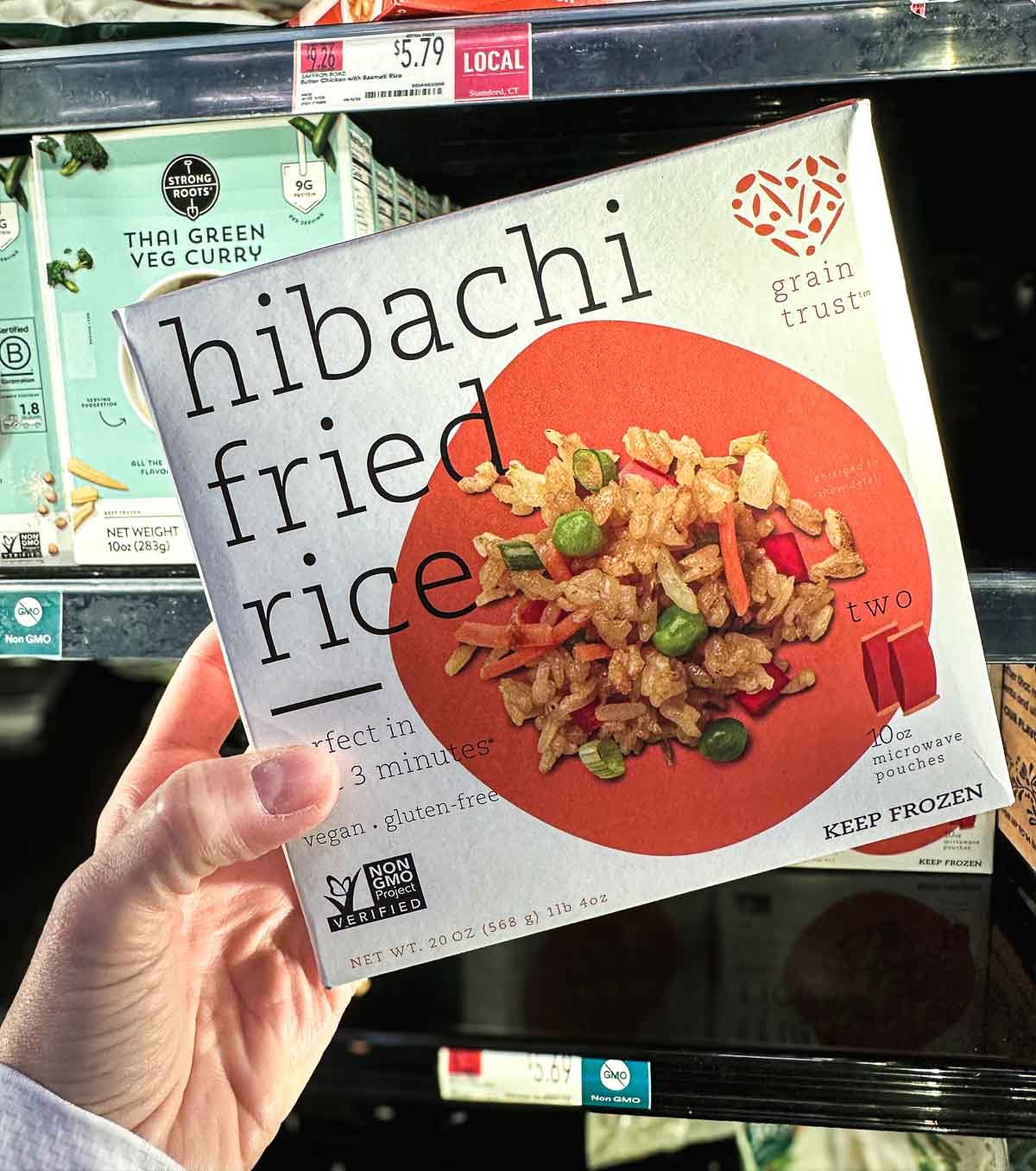 Box of Grain Trust vegan hibachi fried rice made with vegetables and microwave-ready pouches.