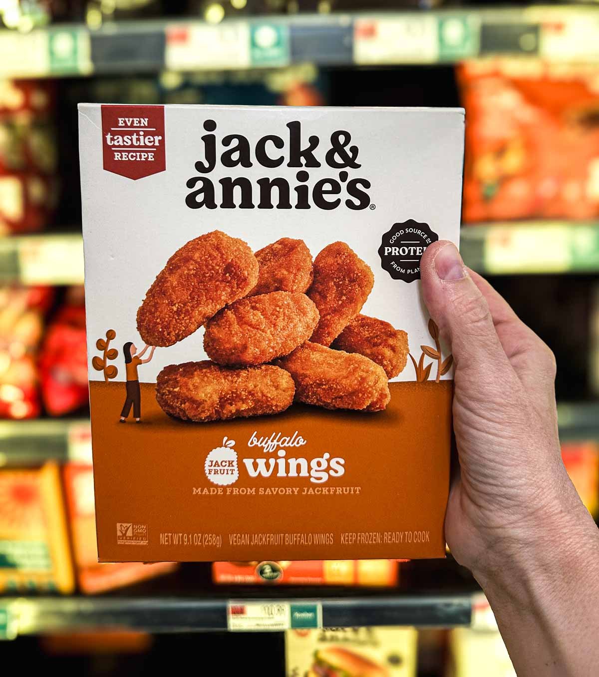 Jack & Annie’s Buffalo Wings frozen box with crispy vegan nuggets made from jackfruit on a white and orange background.