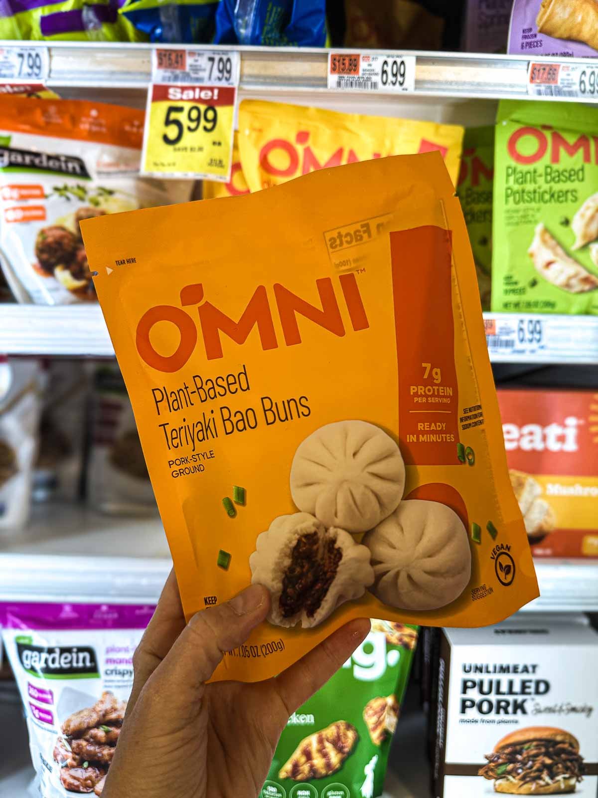 Teriyaki-flavored vegan bao buns with a bold black and red label and close-up of fluffy dumplings.