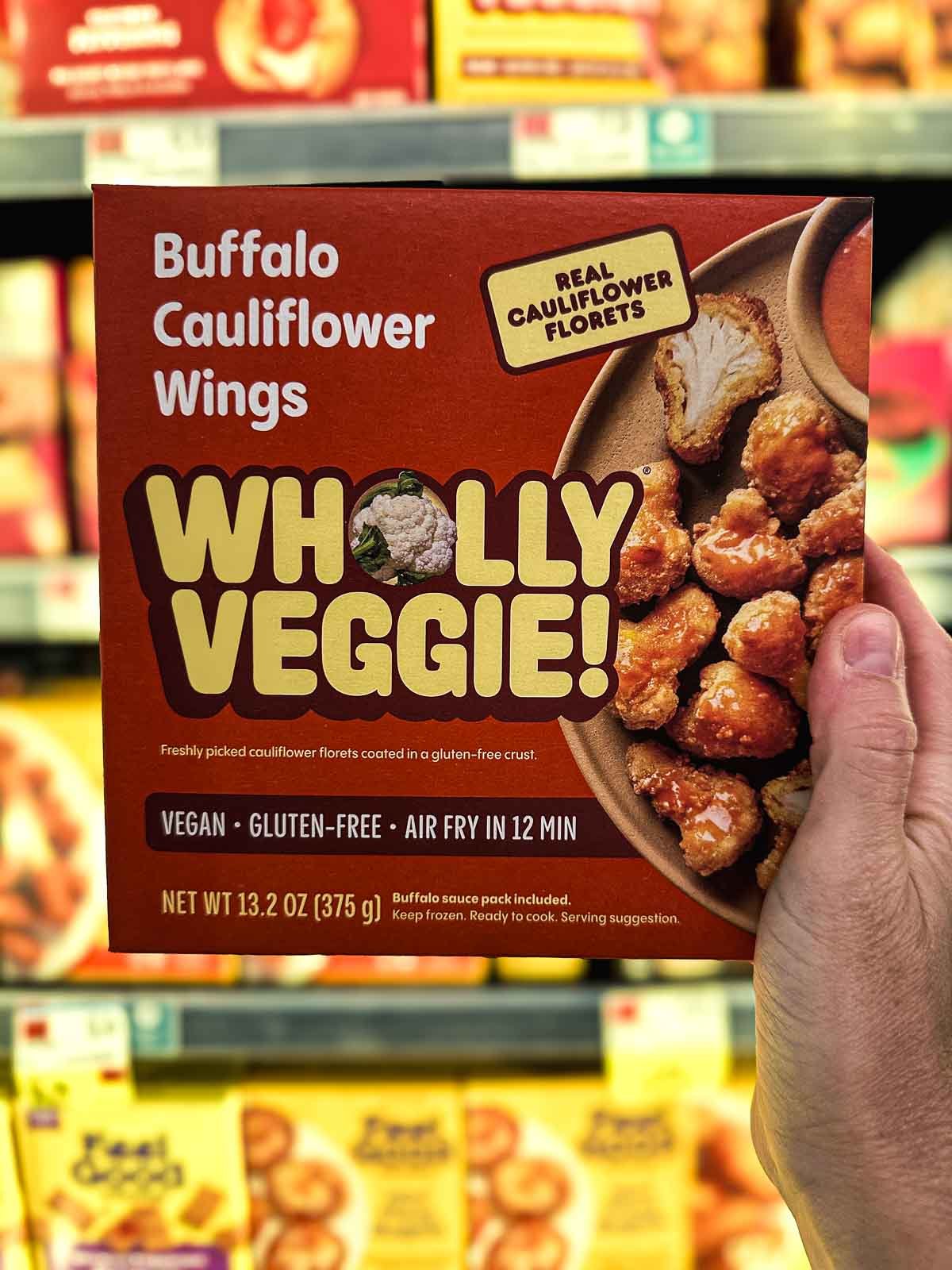 Wholly Veggie Buffalo Cauliflower Wings frozen package showing crispy breaded bites and vegan label.