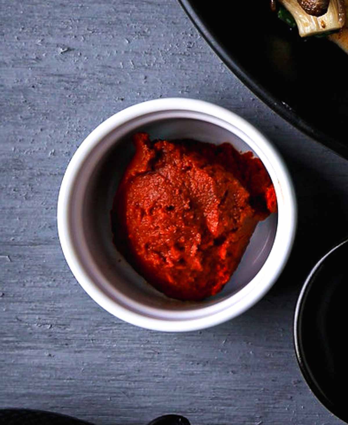 A small amount of Thai red curry paste in a ramekin.