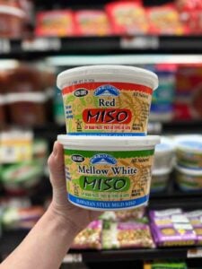 Red miso and mellow white miso paste tubs showing different miso types used for soups, marinades, and sauces.