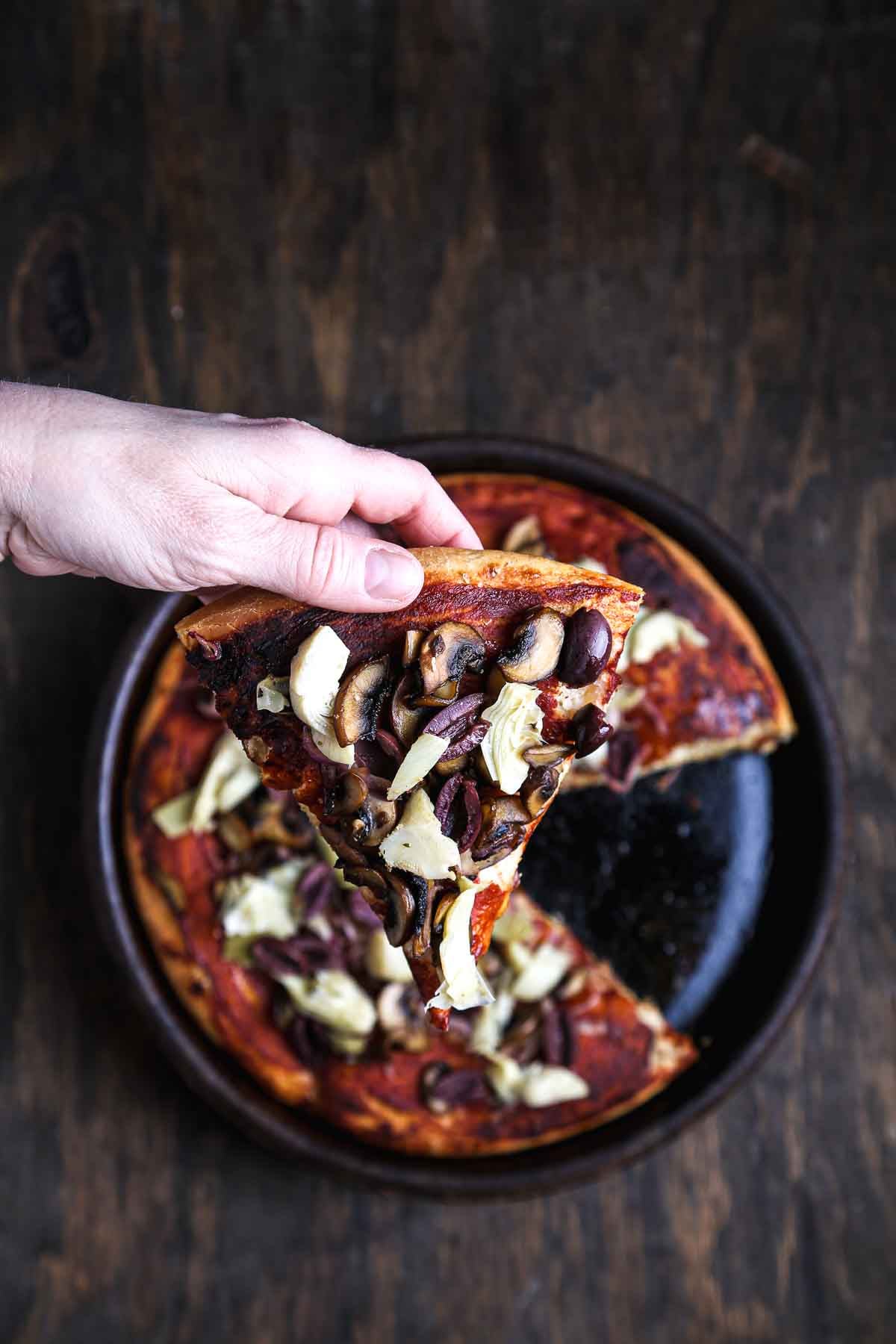 Overhead view of pizza al padellino with one slice removed, showing its tall, airy interior.